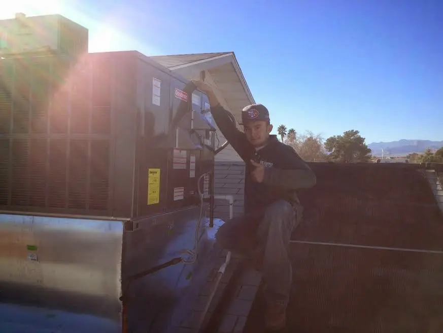 HVAC technician performing HVAC Inspection on a rooftop unit in Stevens Point
